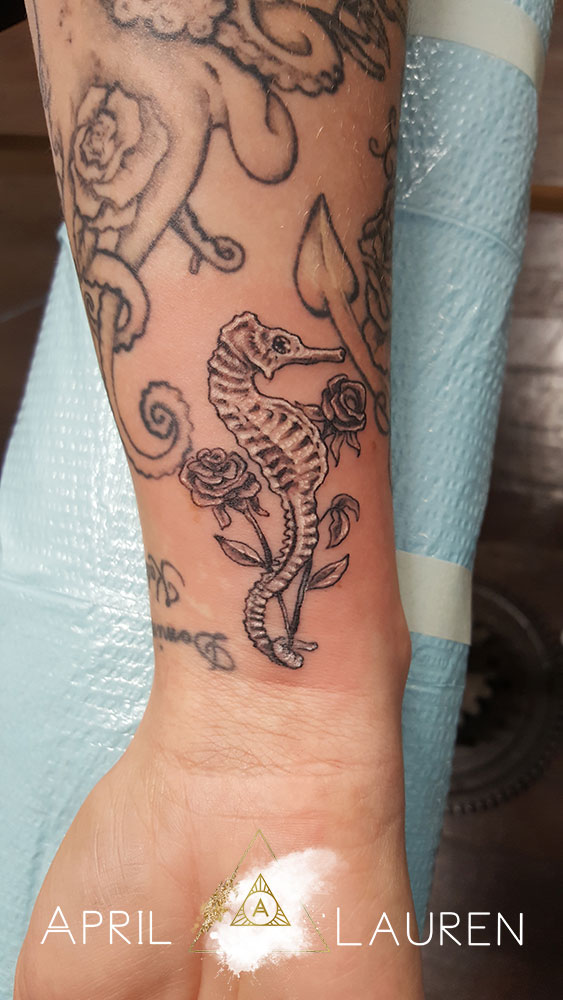black and grey seahorse and flower tattoo by April Lauren at Naya Studio