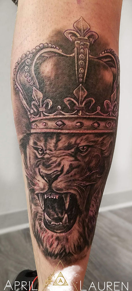 black and grey roaring lion tattoo with crown