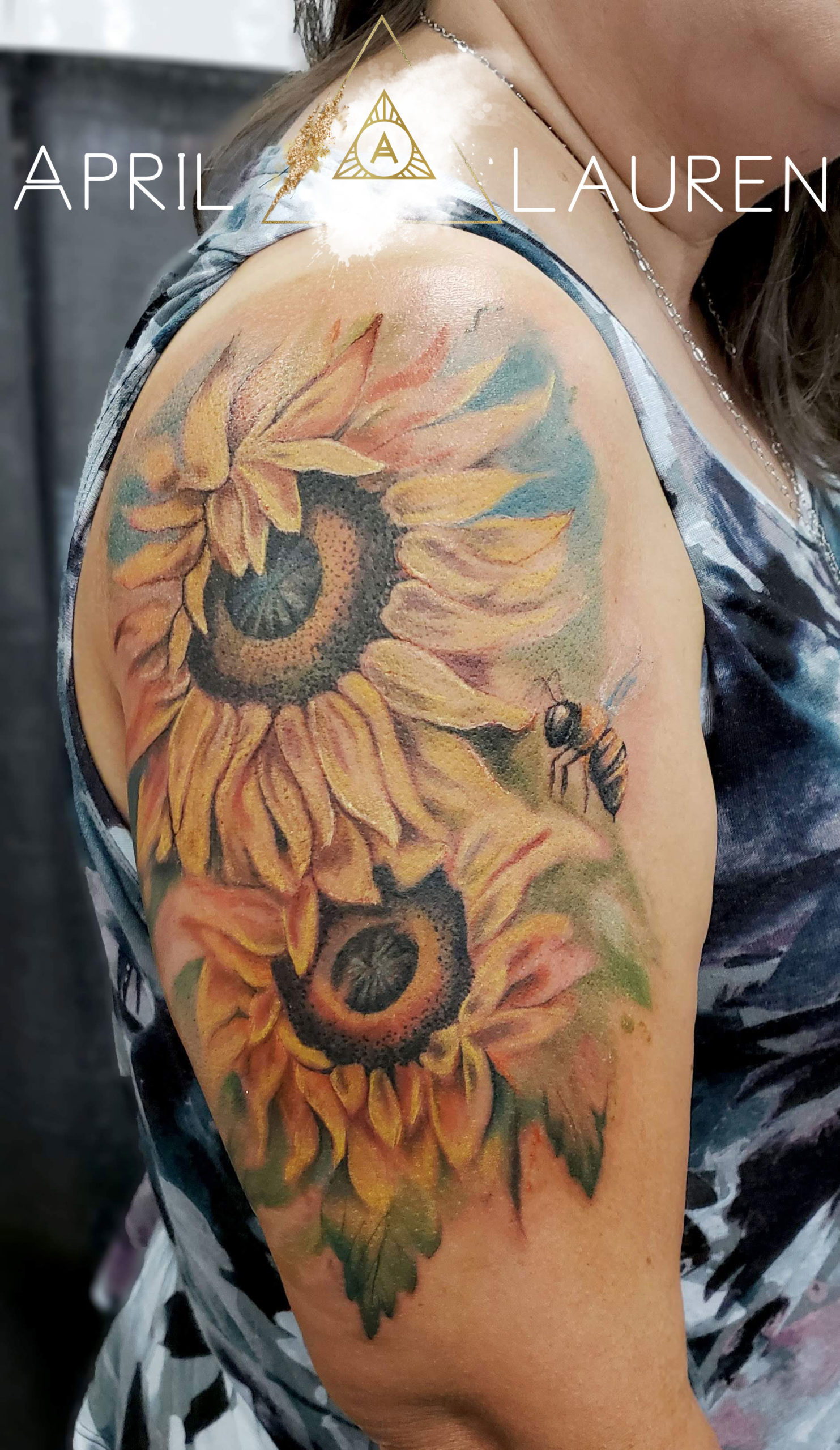 Bee with yellow flowers tattoo by April Lauren at Naya Studio